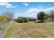 Sprawling backyard featuring a well-kept lawn, mature trees, and a charming fenced-in area at 2983 Greendale Rd, North Port, FL 34287