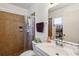 Functional bathroom featuring a shower with tiled walls, vanity and updated fixtures at 2983 Greendale Rd, North Port, FL 34287