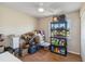 Multi-purpose bedroom featuring laminate floors, a ceiling fan, window and storage at 2983 Greendale Rd, North Port, FL 34287