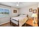 Comfortable bedroom with a ceiling fan, window with blinds, and hardwood style flooring at 2983 Greendale Rd, North Port, FL 34287