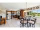 Bright kitchen with stainless steel appliances, wood cabinets, and a modern dining table at 2983 Greendale Rd, North Port, FL 34287