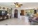 Open concept living area with tile flooring, comfortable seating, and a ceiling fan at 2983 Greendale Rd, North Port, FL 34287