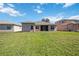 Expansive backyard with green grass and lush surroundings for outdoor enjoyment and relaxation at 312 Londonderry Dr, Sarasota, FL 34240
