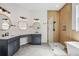 This luxurious bathroom features double sinks, a glass shower and a soaking tub at 312 Londonderry Dr, Sarasota, FL 34240