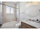 Bathroom featuring a vanity with marble countertop, a shower-tub combo, and neutral decor at 312 Londonderry Dr, Sarasota, FL 34240