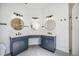 A spacious bathroom features a dual sink vanity, modern mirrors, and a walk-in shower at 312 Londonderry Dr, Sarasota, FL 34240