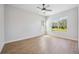 This light-filled bedroom offers two large windows, a ceiling fan, and wood look flooring at 312 Londonderry Dr, Sarasota, FL 34240