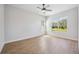 Bedroom with luxury vinyl flooring, large windows, and a modern ceiling fan at 312 Londonderry Dr, Sarasota, FL 34240