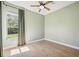Light green bedroom featuring hardwood floors, a ceiling fan, a bright window, and neutral walls at 312 Londonderry Dr, Sarasota, FL 34240