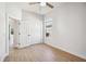Neutral bedroom featuring hardwood floors, a ceiling fan, a closet, a bright window, and neutral walls at 312 Londonderry Dr, Sarasota, FL 34240