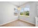 Well-lit room with wood flooring and a large window with views of the outdoors at 312 Londonderry Dr, Sarasota, FL 34240