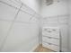Walk-in closet featuring shelving, a hanging rack and a built-in dresser for storage at 312 Londonderry Dr, Sarasota, FL 34240