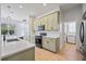 Stylish kitchen with green cabinets, quartz countertops, and stainless steel appliances at 312 Londonderry Dr, Sarasota, FL 34240