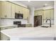 Modern kitchen featuring quartz countertops and stainless steel appliances at 312 Londonderry Dr, Sarasota, FL 34240