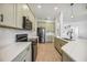 Modern kitchen featuring stainless steel appliances, stone countertops, and light green cabinetry at 312 Londonderry Dr, Sarasota, FL 34240