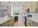 Open kitchen with large island, pendant lights, and stainless steel appliances at 312 Londonderry Dr, Sarasota, FL 34240