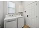A well-lit laundry room features a washer, a dryer, and plenty of storage space at 312 Londonderry Dr, Sarasota, FL 34240