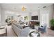 Bright living room featuring modern furnishings, wood floors, and a large media center at 312 Londonderry Dr, Sarasota, FL 34240
