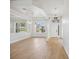 Bright living room featuring wood floors, a large window, and modern lighting fixtures for a stylish and inviting space at 312 Londonderry Dr, Sarasota, FL 34240
