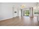 Open floorplan living room showcasing wood flooring, recessed lighting, speakers, and access to the outdoor patio at 312 Londonderry Dr, Sarasota, FL 34240