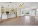 Bright open room with wood floors, and a kitchen offering a bright space and seamless transition between rooms at 312 Londonderry Dr, Sarasota, FL 34240