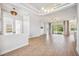 Bright and spacious living room featuring wood floors, recessed lighting, and sliding glass doors to outdoor area at 312 Londonderry Dr, Sarasota, FL 34240