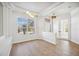 Bright open room with wood floors, a large window, modern lighting fixtures and a french door for a stylish space at 312 Londonderry Dr, Sarasota, FL 34240