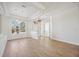 Bright living area with wood floors, large window, entry and a tray ceiling adding architectural interest at 312 Londonderry Dr, Sarasota, FL 34240