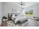 A luxurious main bedroom offers a king bed, bench, and a view of the lawn at 312 Londonderry Dr, Sarasota, FL 34240