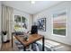 Bright office space with modern desk, decor, and natural light from the large window overlooking the front yard at 312 Londonderry Dr, Sarasota, FL 34240