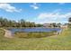 Scenic view of the backyard pond, perfect for enjoying nature and relaxing by the water's edge at 312 Londonderry Dr, Sarasota, FL 34240