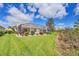 Beautiful backyard featuring a screened lanai and lush landscaping at 339 Marsh Creek Rd, Venice, FL 34292