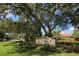 Inviting gated community entrance with lush landscaping and mature trees creating a warm welcome at 339 Marsh Creek Rd, Venice, FL 34292