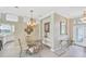 Cozy dining area with elegant chandelier and glass-top table with seating for four at 339 Marsh Creek Rd, Venice, FL 34292