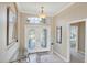 Inviting entryway features beautiful double doors, a chandelier, and neutral-colored tile flooring at 339 Marsh Creek Rd, Venice, FL 34292
