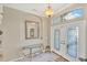 Inviting foyer with decorative glass doors and transom window at 339 Marsh Creek Rd, Venice, FL 34292