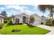 Charming single-story home featuring a pristine lawn, well-maintained landscaping, and an attached garage at 339 Marsh Creek Rd, Venice, FL 34292