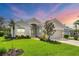 Beautiful single-story home with lush landscaping, a tile roof, and a well-manicured lawn at 339 Marsh Creek Rd, Venice, FL 34292
