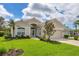 Beautiful single-story home with lush landscaping, a tile roof, and a well-manicured lawn at 339 Marsh Creek Rd, Venice, FL 34292