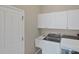 Efficient laundry area with washer, dryer, utility sink and ample storage at 339 Marsh Creek Rd, Venice, FL 34292