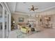 Bright living room with modern ceiling fan, and access to the outdoor patio at 339 Marsh Creek Rd, Venice, FL 34292