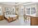 Sun-filled bedroom with large windows, neutral decor, and tile floors at 339 Marsh Creek Rd, Venice, FL 34292