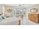 Comfortable bedroom with serene décor, bright windows, and tile flooring at 339 Marsh Creek Rd, Venice, FL 34292