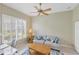 Cozy home office with a comfortable sofa, natural light, and a ceiling fan at 339 Marsh Creek Rd, Venice, FL 34292