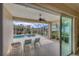Screened patio with chairs, providing a clear view of the pool and landscaped backyard at 339 Marsh Creek Rd, Venice, FL 34292