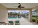 Relaxing screened pool patio with ceiling fan and comfortable lounge chairs at 339 Marsh Creek Rd, Venice, FL 34292