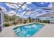 Enjoy this screened pool and spa with peaceful backyard views at 339 Marsh Creek Rd, Venice, FL 34292