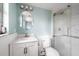 Well-lit bathroom featuring a vanity with storage and a shower with glass doors at 400 Base E Ave # 213, Venice, FL 34285