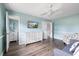 Well-lit bedroom with ceiling fan and a view into the attached bathroom at 400 Base E Ave # 213, Venice, FL 34285