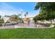 Inviting community park with a charming water fountain and shaded seating areas for relaxing and socializing at 400 Base E Ave # 213, Venice, FL 34285